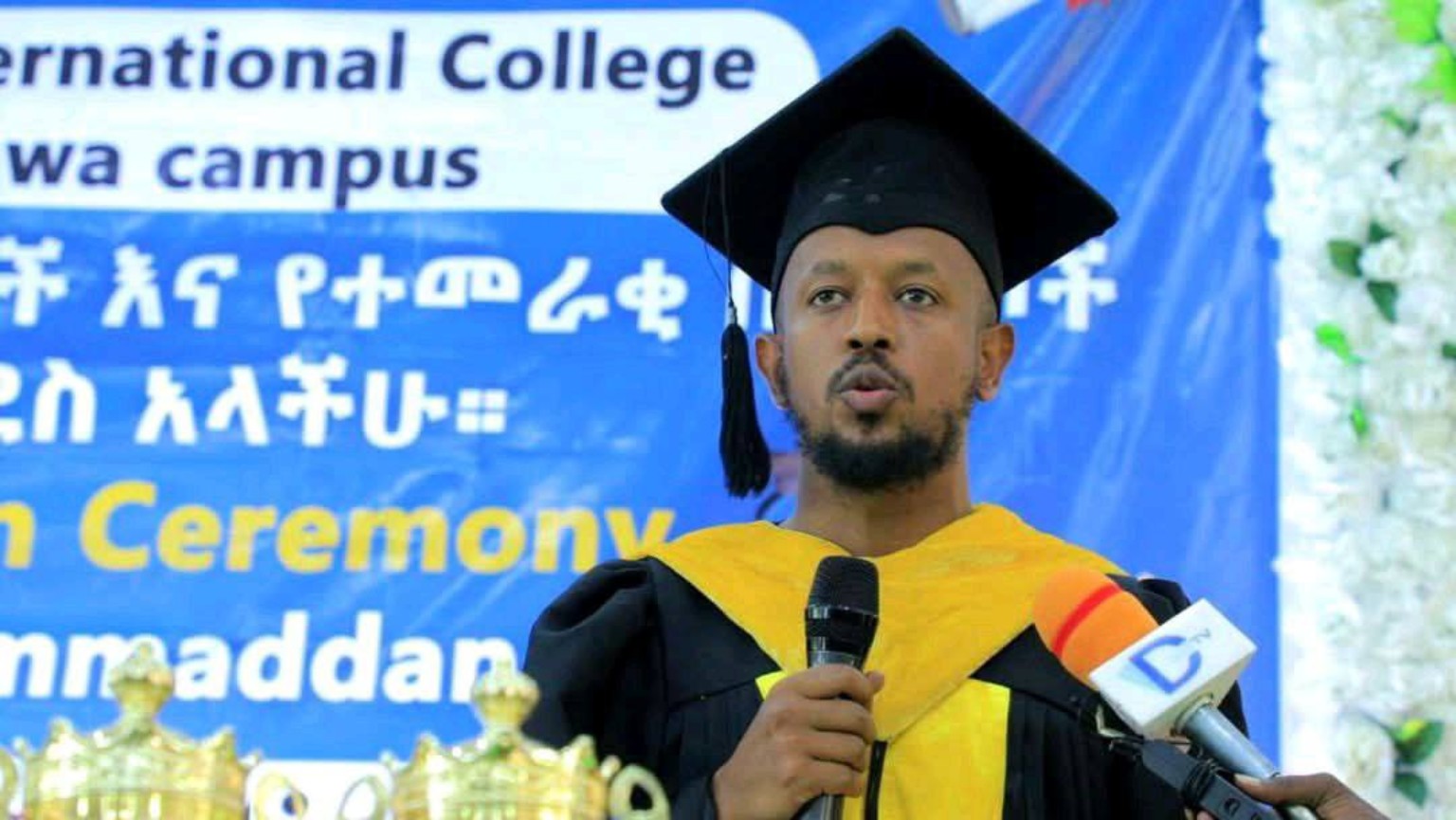 Ol-Bright graduate speaking during a campus ceremony
