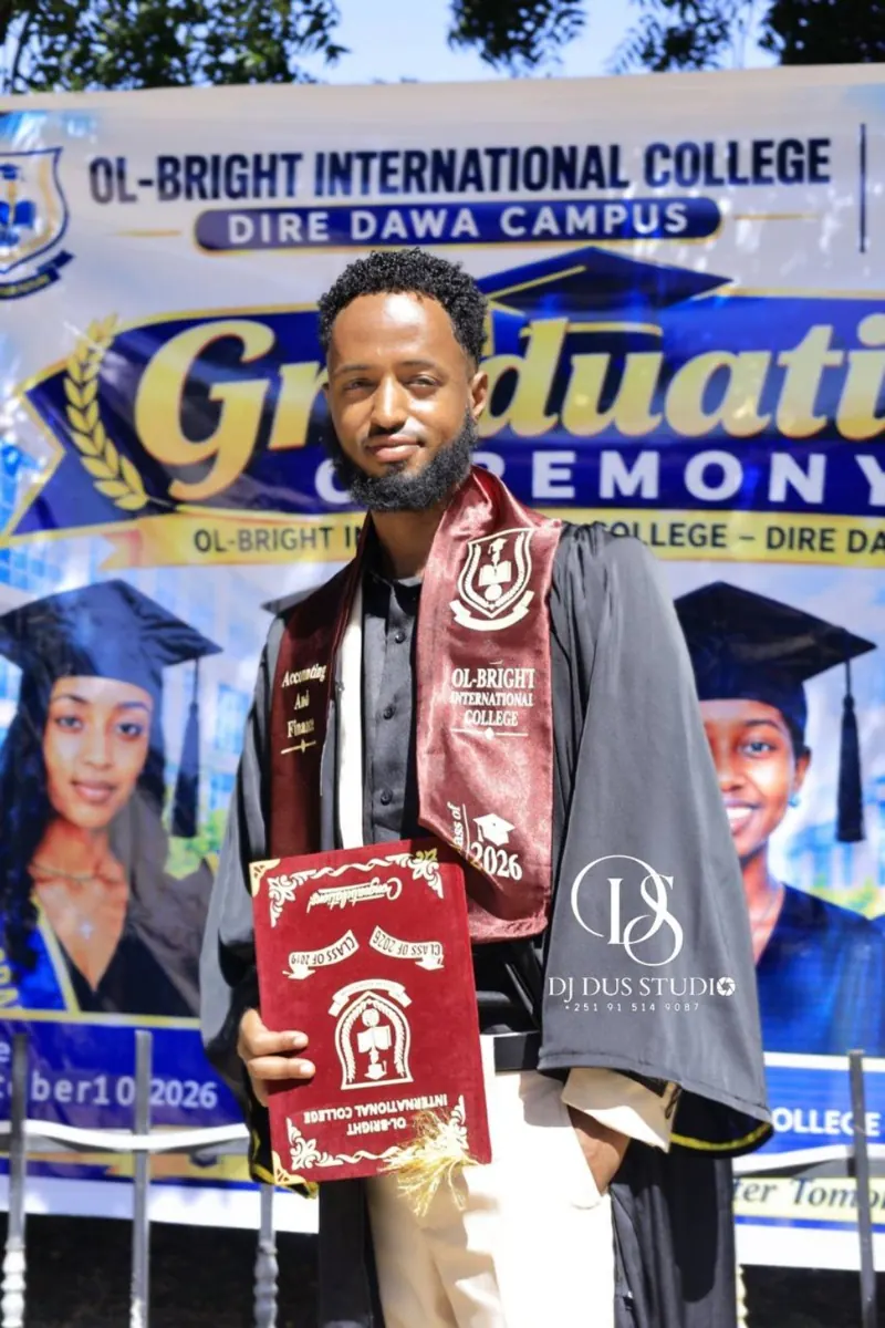 A graduate proudly displays his graduation stole