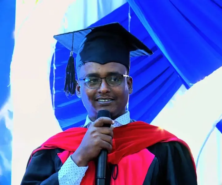 A speaker addresses the graduates